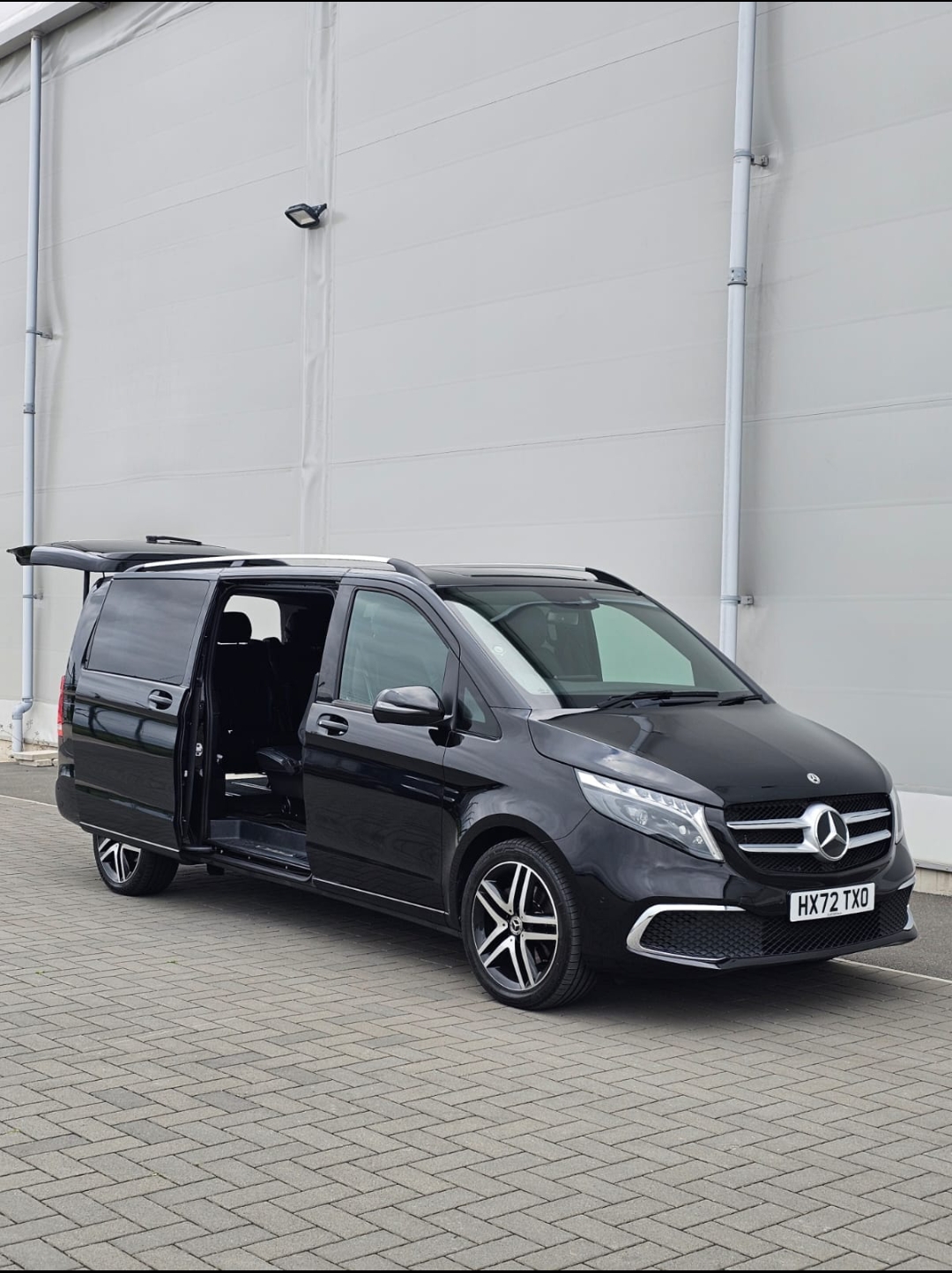 Mercedes-Benz V-Class Chauffeur Service — the XLWB with doors open at the hangar
