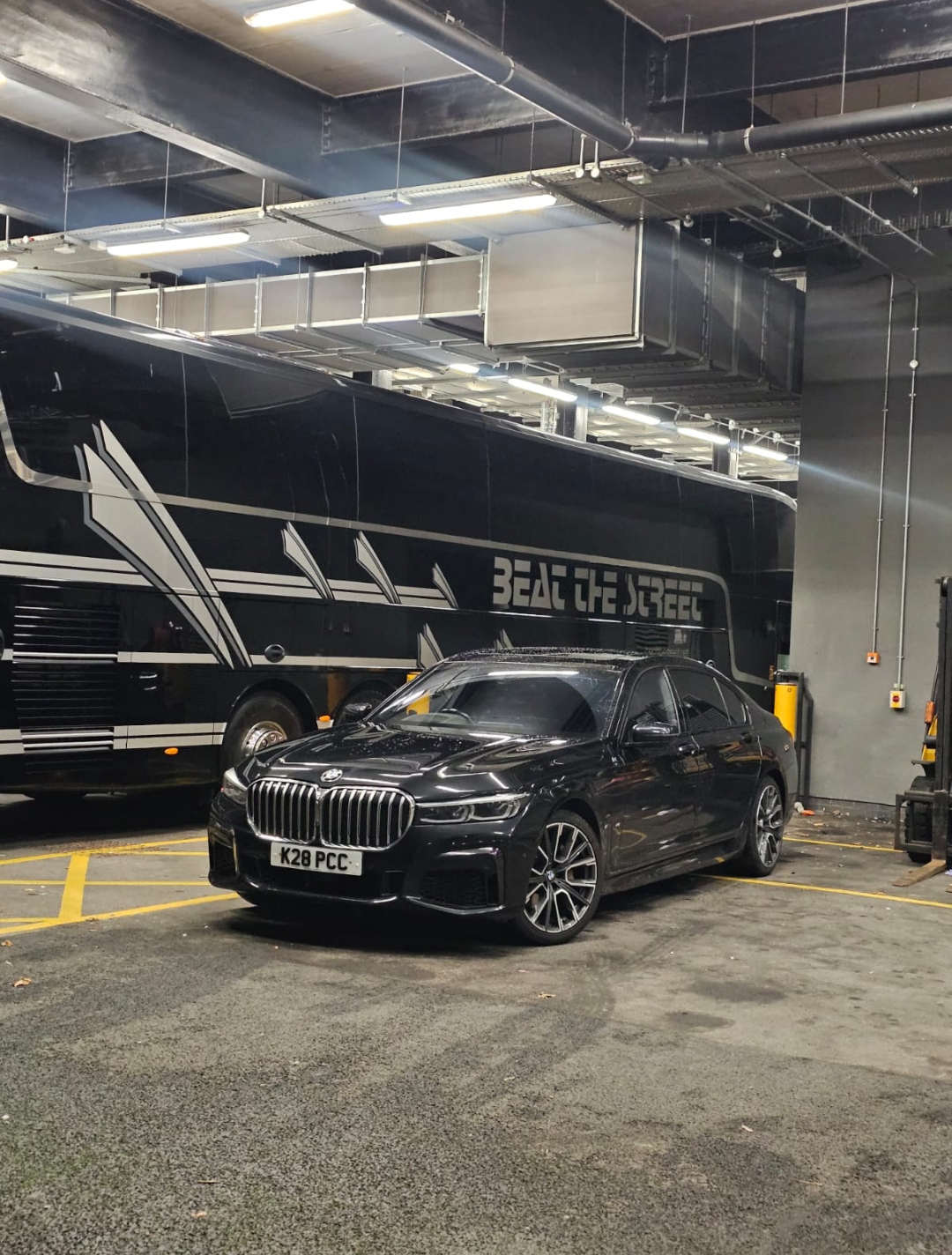 BMW 7 Series Executive beside the artist tour bus — Primex Chauffeurs