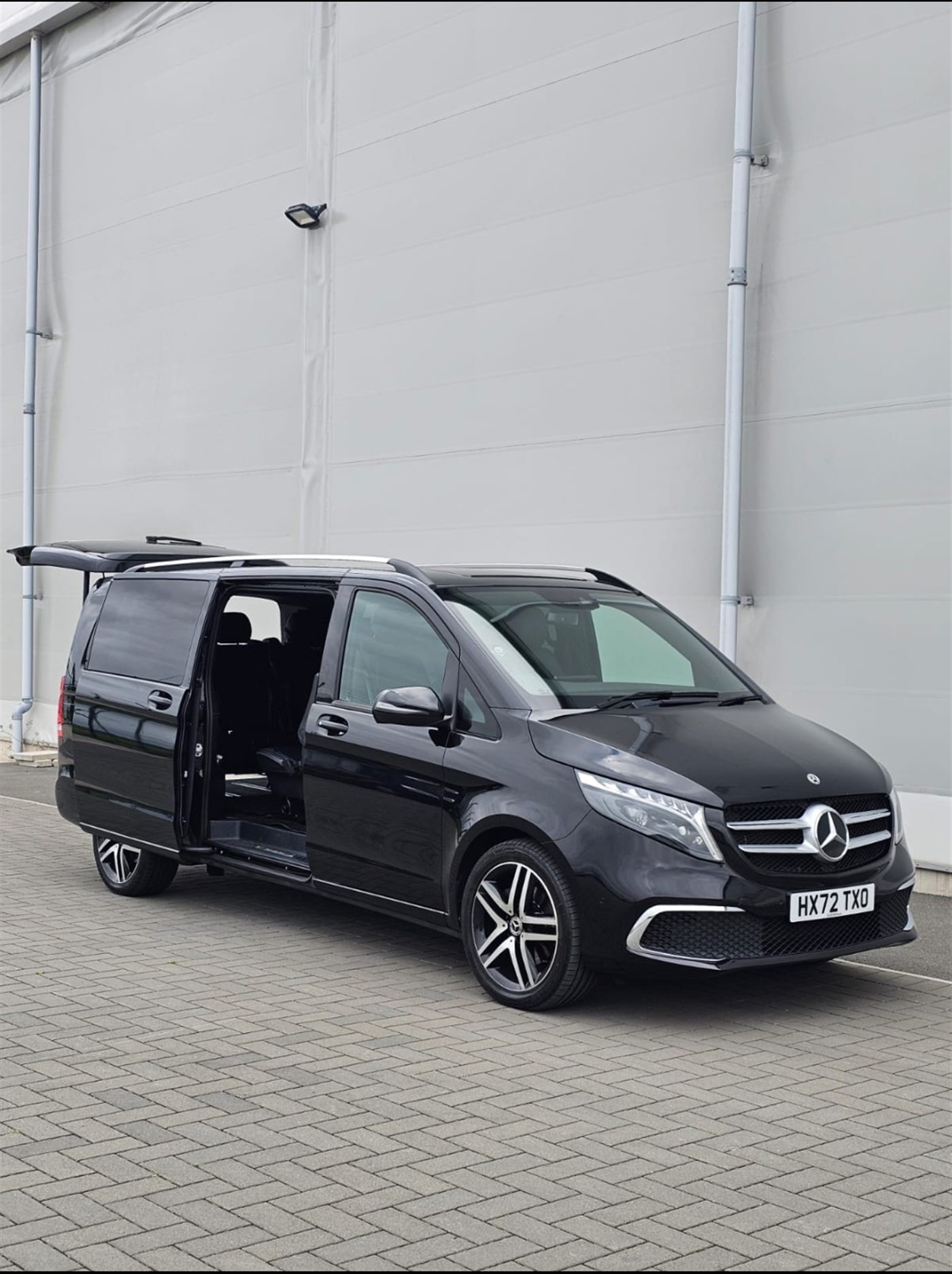Wheelchair-accessible vehicle with the ramp deployed — Primex Chauffeurs